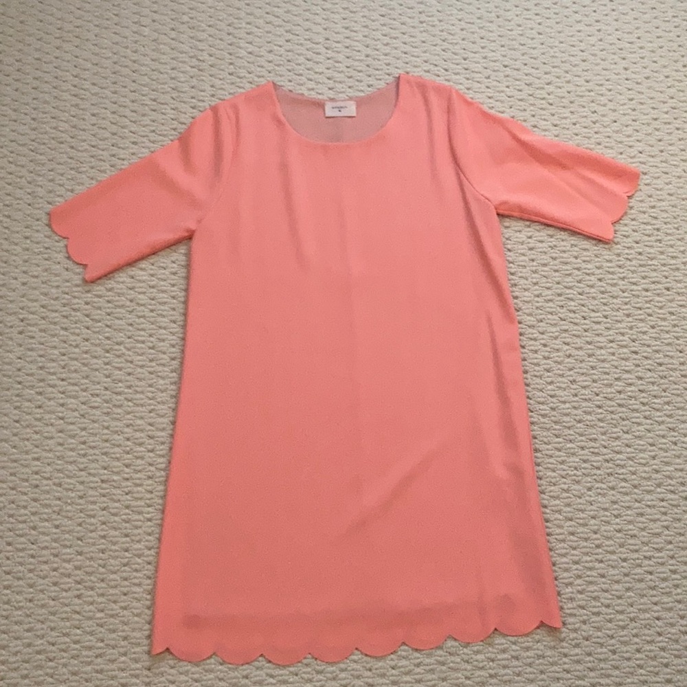 Salmon color dress.